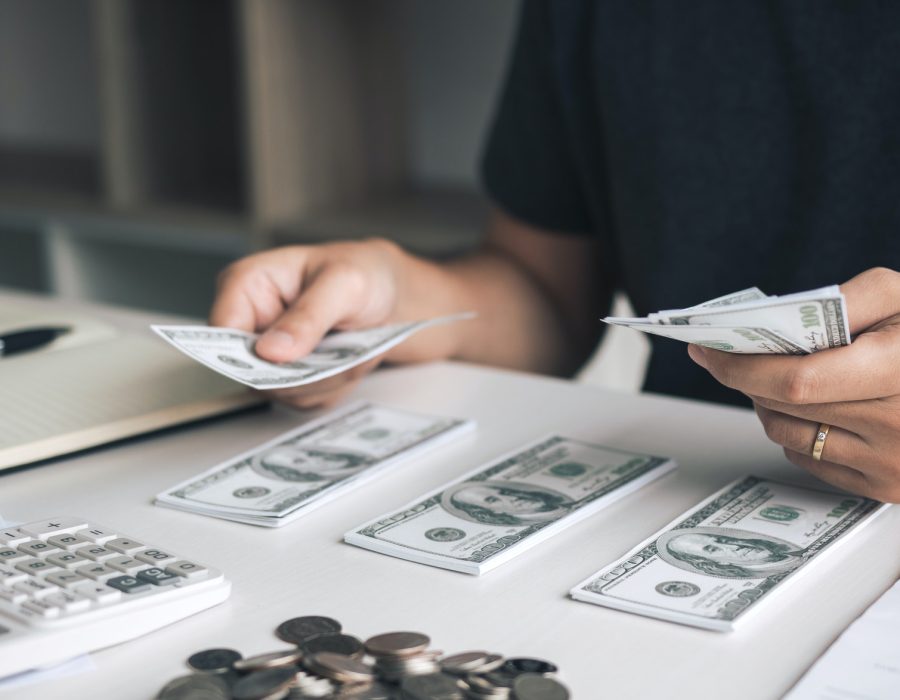 asian-men-are-holding-banknotes-in-cash-and-placed-on-the-table-with-the-idea-of-saving-money-.jpg